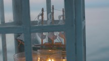 Outdoor lantern with ship model and candles