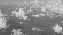 Aerial view of small fluffy clouds and land