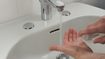 Man carefully washing hands for health safety