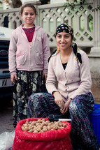 Mother and daughter selling walnuts