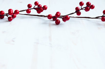 red berries on a white wood background 