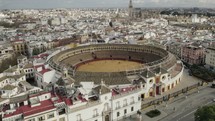 Plaza de Toros or bullring and cityscape, Seville in Spain. Aerial circling