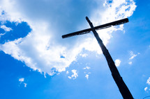 wooden cross silhouette against a blue sky 