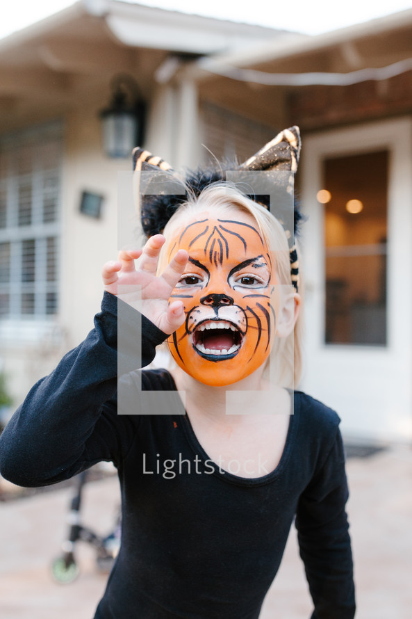 Girl with tiger face paint 