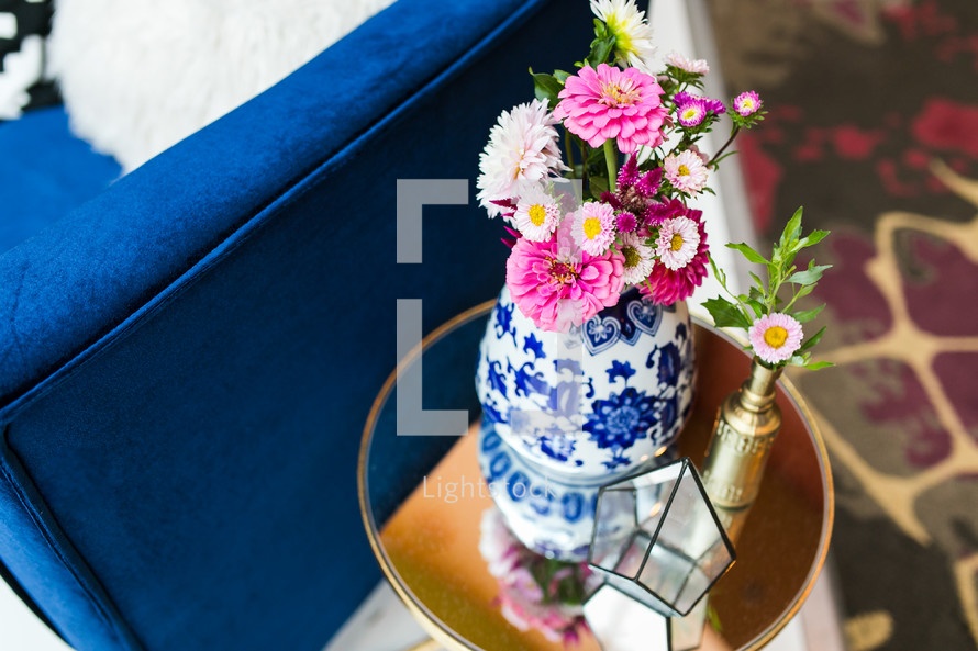 pink flowers in a blue and white vase 