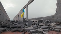 Waving Ukraine flag on a building destroyed in the war with Russia