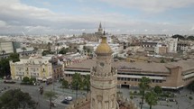 Orbiting over gold tower dome revealing Cityscape Panoramic views, Seville - Spain