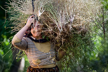 Kurdish woman carrying herbs