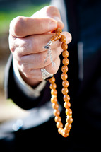 hand holding prayer beads