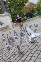 Woman feeding pigeons