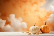Halloween pumpkins on wooden table with orange sky and clouds background