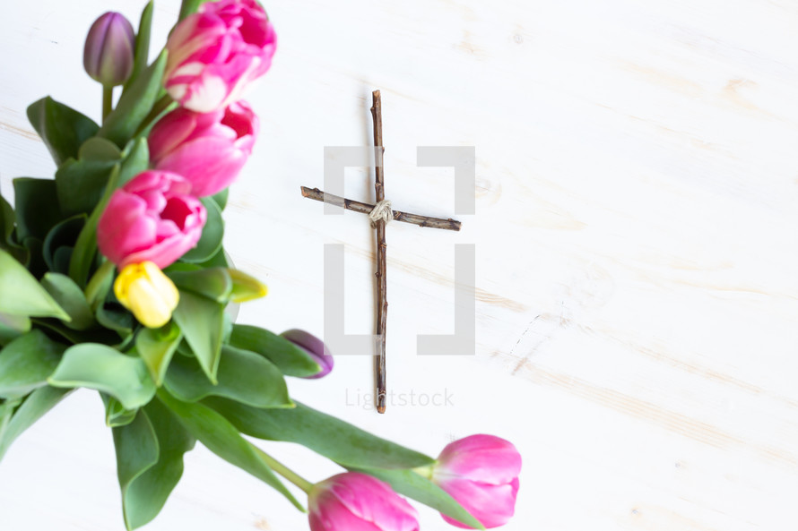 cross made of sticks and tulips 