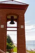 bell tower by a lake shore 