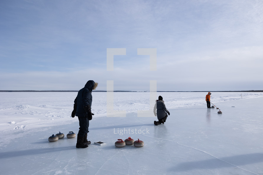 Family curling on a lake