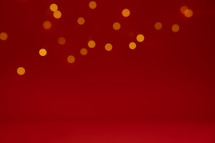 Border of unfocused lights on a red background with copy space