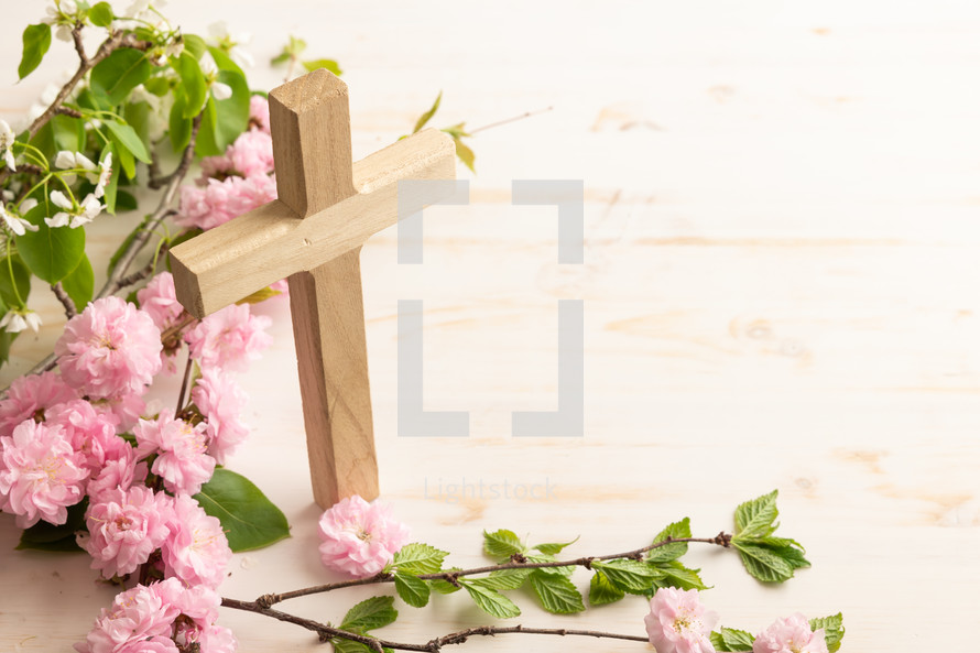 Cross with branch with pink flower blossoms