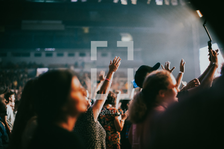 hands raised in worship at a Christian concert in Prague 