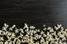 popcorn on a black wood background 