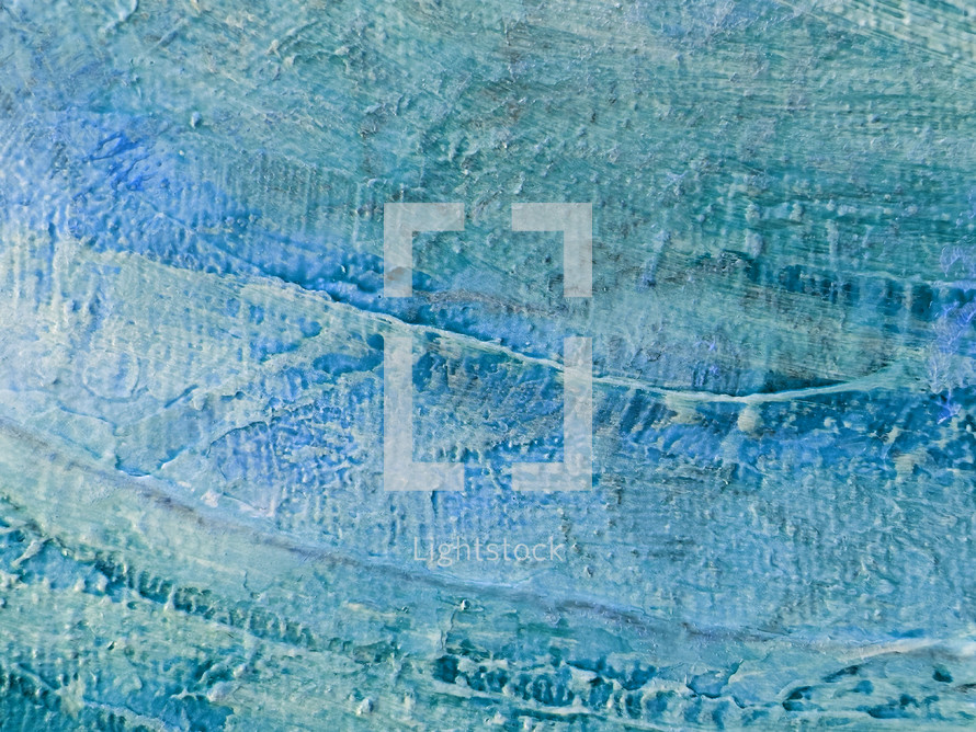 closeup of canvas surface with rough textures and blue and green paint