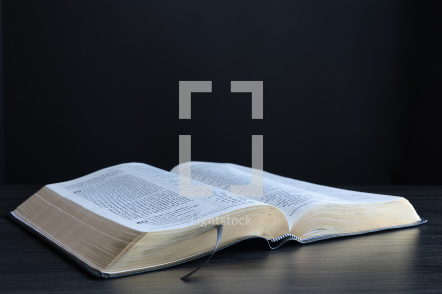 Open bible on a black background