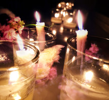 Double exposure candles and flowers in dark space - soft effect