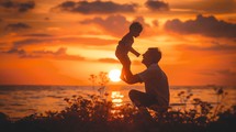 Dad playing with son at sunset