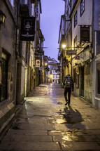a man on the streets of Santiago Compostella at night 