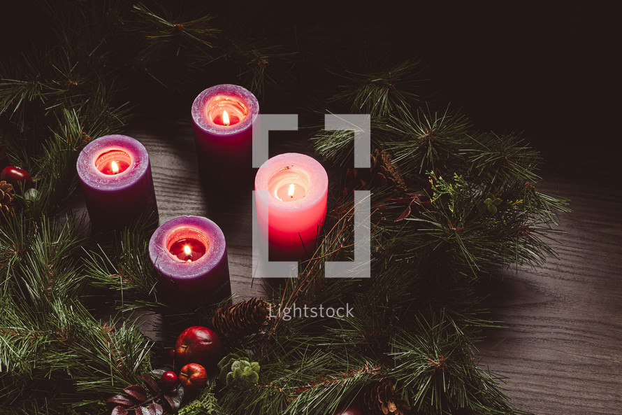 Rustic advent wreath with four candles lit shot from above with copy space