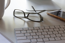 reading glasses on a desk 