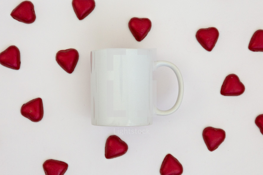 red heart shaped chocolates and white mug 