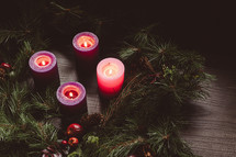 Rustic advent wreath with four candles lit shot from above with copy space