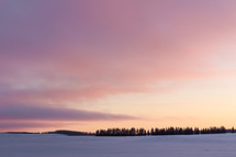 winter sunset over a snow covered field 