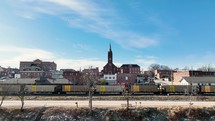 Cathedral church on a hill over a moving train in a small town during winter. Washington, Missouri