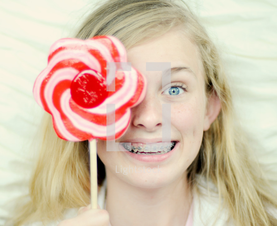 Teenager holding lollypop