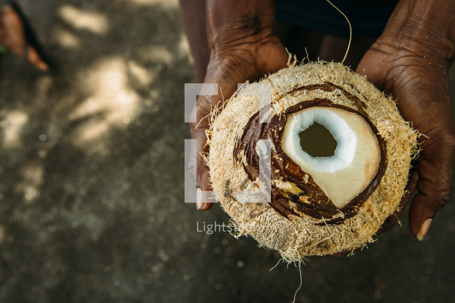 a man holding a coconut 