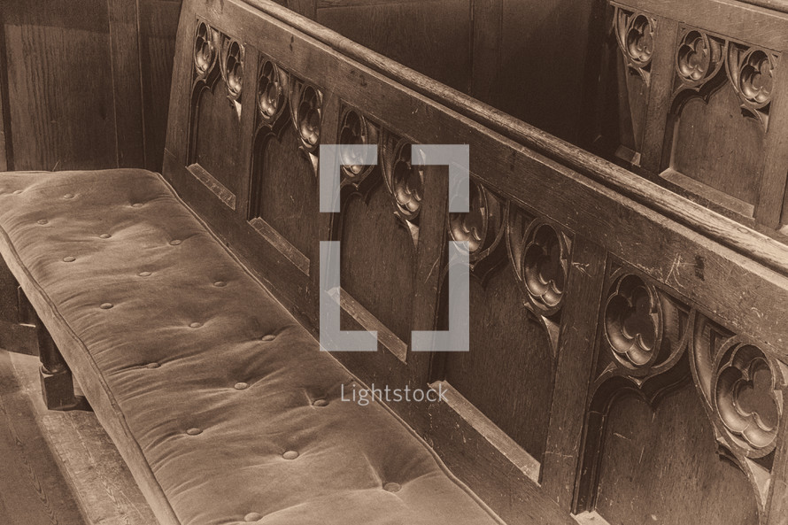 Church Pew with Velvet Cushion and Wooden Carvings in Sepia