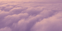 purple, pink and peach puffy clouds viewed from above