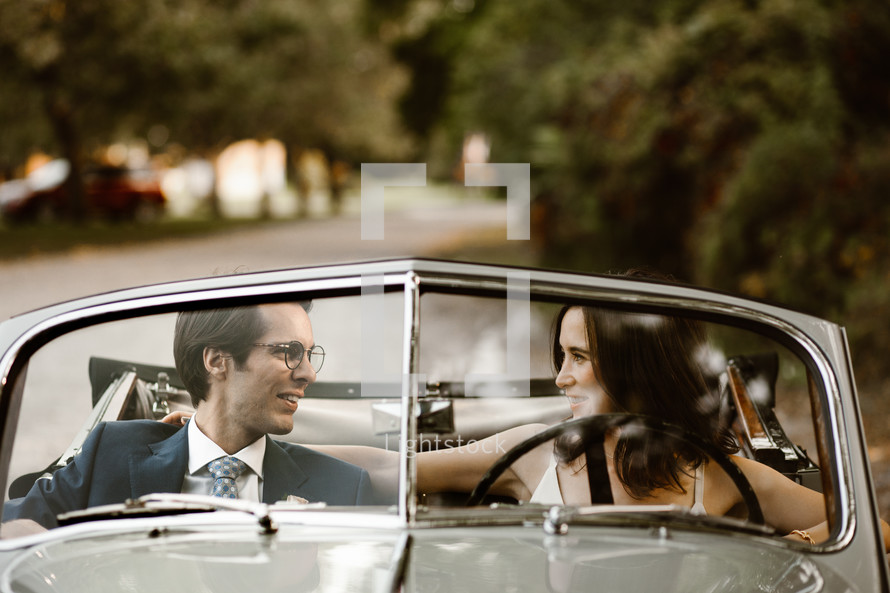 bride and groom in a vintage car 