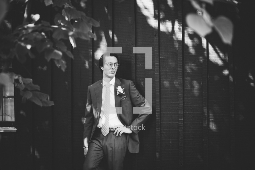 a groom standing outdoors posing 