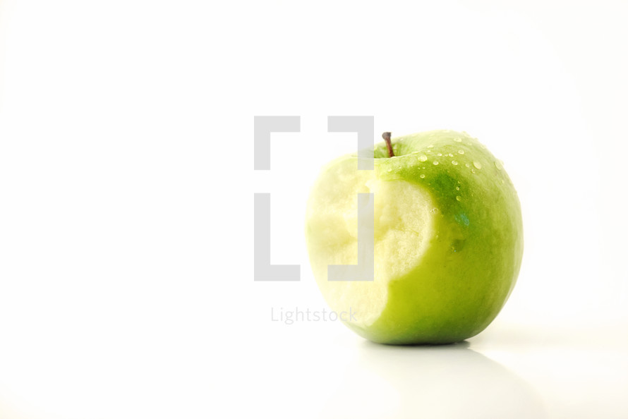 a bite out of a green apple 