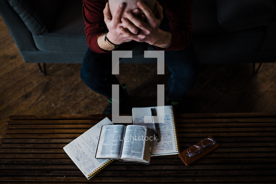 a distressed man reading a Bible for comfort 