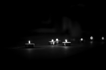 votive candles in darkness 