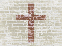 beige brick wall with centered brick red cross