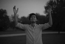 man with hands raised in worship to God 