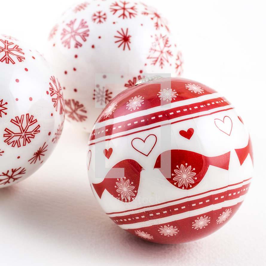 Red and white Christmas balls on a white background.
