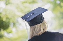 a teen girl in cap and gown for graduation 