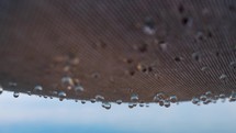 Raindrops falling from textile shed outdoor