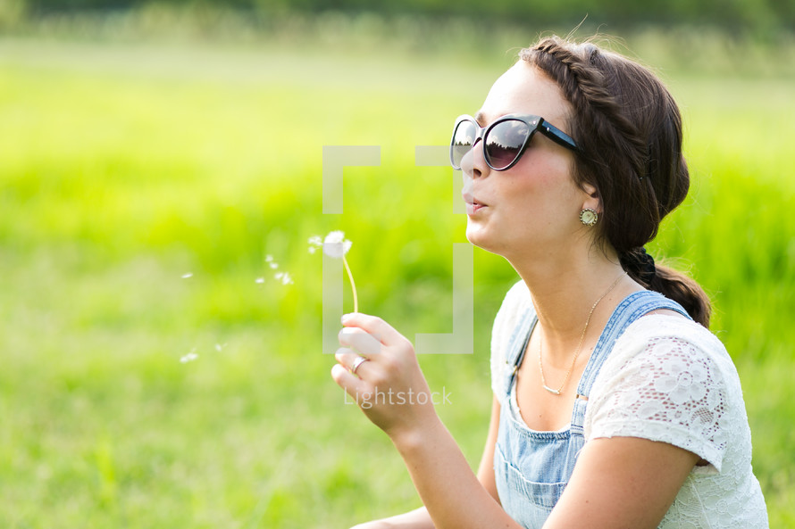 blowing a dandelion 
