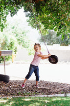 a toddler girl with a tire swing 