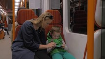 Shot of mother and son ride in the subway train